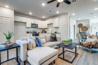 Living room featuring sink, ceiling fan, and light hardwood / wood-style flooring