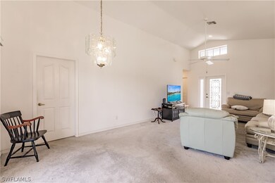 Living room featuring ceiling fan with notable cha