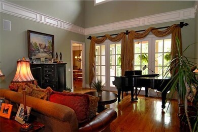 The living room is front and center as you enter from the foyer. Dramatic two story height!