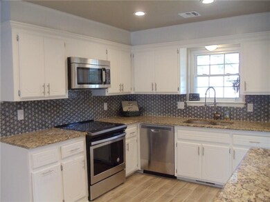 New stainless steel appliances, faucet & sink.