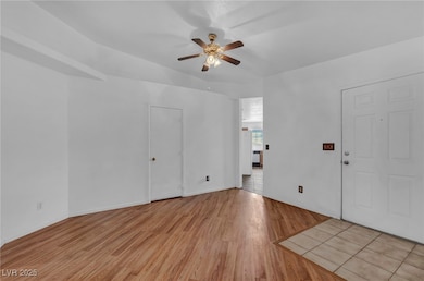 Unfurnished room featuring a ceiling fan and light