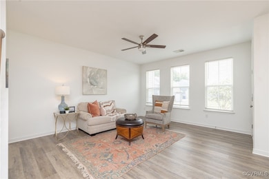 Living room featuring ceiling fan and wood finishe