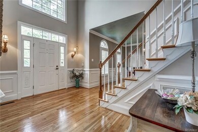 Warm and spacious Foyer with beautiful moldings, a