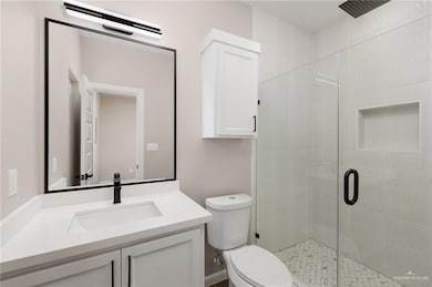 Bathroom featuring a shower stall and vanity
