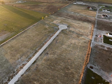 Aerial view of property and surrounding area with rural landscape and large plots for crops