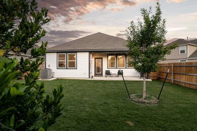 Rear view of house with a patio and a shingled ro