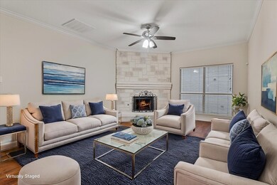 Living room with ceiling fan, ornamental molding, 
