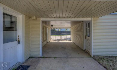 Covered carport with entry to backyard
