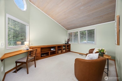 There is a spacious office or TV room off the entry with a built-in entertainment center or bookcases.