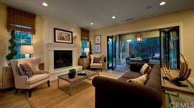 Spacious family room with cozy fireplace and recessed lighting- as shown in model