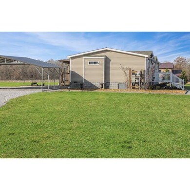 3 car carport detached at back left of home