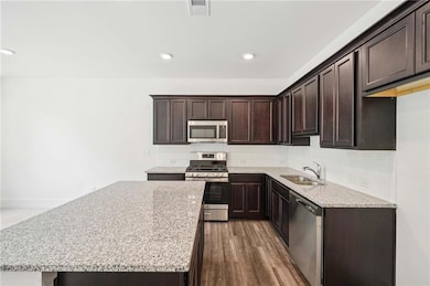 Granite and Stainless Appliances with Stained Cabinets