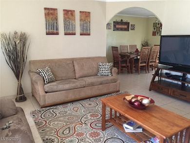 Living area with arched walkways, ornamental moldi