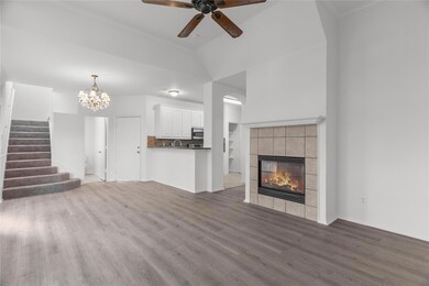 Unfurnished living room with a tiled fireplace, ce