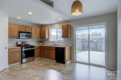 Kitchen with stainless steel appliances, light countertops, a textured ceiling, recessed lighting, and brown cabinets