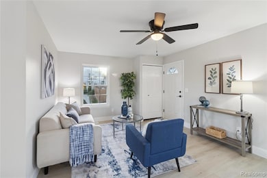 Living area featuring wood finished floors and ceiling fan