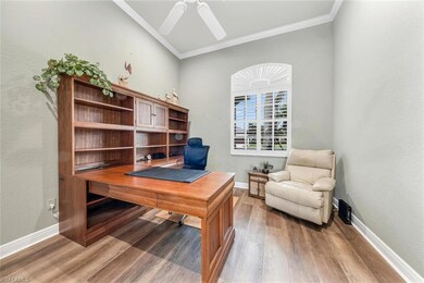 Office space with ceiling fan, wood-type flooring,