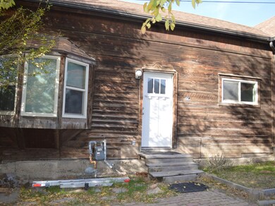 Property entrance featuring roof with shingles