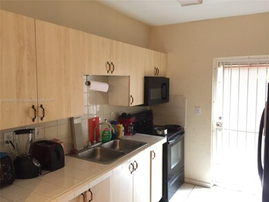 Kitchen with french door to another balcony