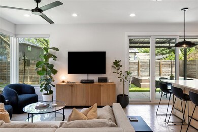 Living area featuring a ceiling fan, recessed lig