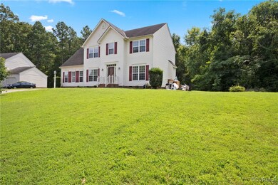 Colonial-style house with a front yard