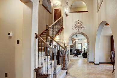 Guests will be amazed with this grand entrance which boasts high ceilings that exceeds 19' and updated light fixtures