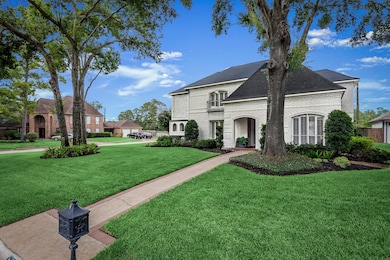 Note the professionally landscaped yard and the inlaid brick, lining the pathway to the front door.