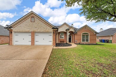 View of front of property with brick siding, concr