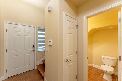 Tiled foyer with baseboards