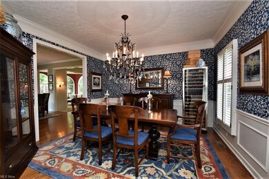 Gorgeous dining room with hardwood flooring, wains