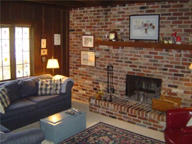 Family Room. A full wall of brick in this family room.  The ceiling is accented with wood beams.