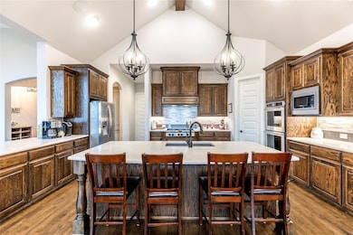 Did you notice all the seating and how open this is to the family room? How about the beamed ceiling and the striking light fixtures?