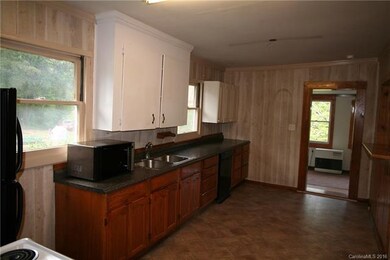 country kitchen looking to newer addition/family r