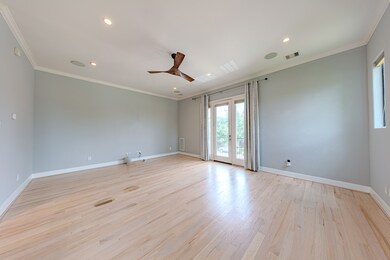 This spacious, light-filled living room features h