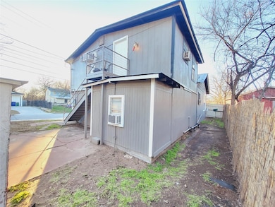 Rear view of house featuring a balcony, fence, a 