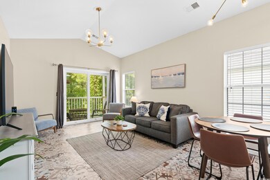 Living room with a chandelier and vaulted ceiling