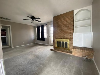 Unfurnished living room with visible vents, a bric