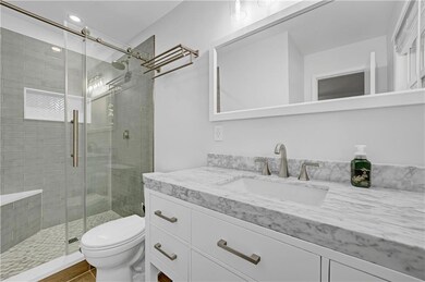 Full bathroom with vanity, a stall shower, and recessed lighting