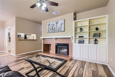 Unfurnished living room featuring ceiling fan, ba