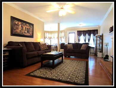 Spacious Living Room with Warm Hardwoods and Woodburning Fireplace.