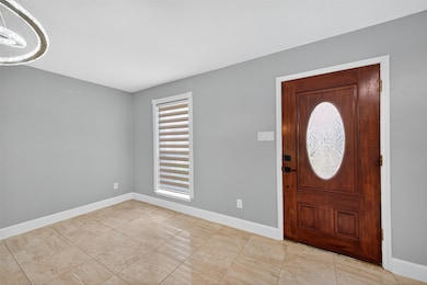 Bright entry area with new tile flooring and natur