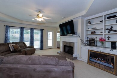 Living room with gas fireplace and built-in cabine