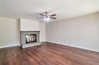 Unfurnished living room with dark wood finished fl