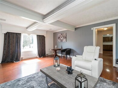 Large spacious living room with neutral paint colors and laminate flooring.