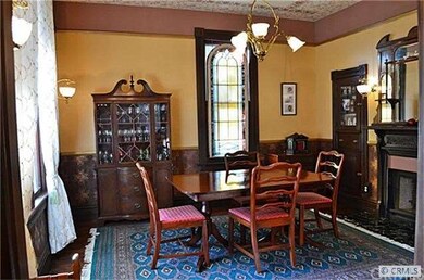 DININGROOM WITH 12 FT CEILINGS , FIREPLACE &STAINE