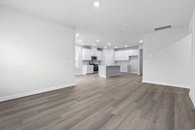 Unfurnished living room with sink and light wood-t
