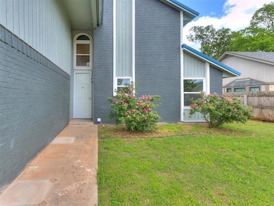 View of exterior entry featuring brick siding