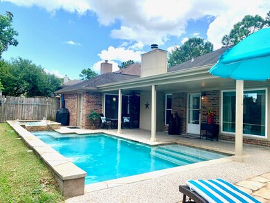 Absolutely Fabulous Back Elevation with Great Covered Porch, Grill Area, Pool and Hot Tub and yard space too