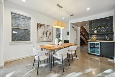 Dining room with wine cooler, concrete flooring, 