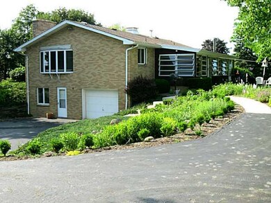 Exterior Back. Professionally landscaped gardens.